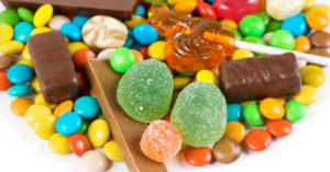 A variety of candies and sweets on a white background.