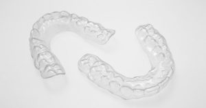 A pair of clear braces on a white surface.