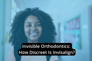 A smiling person with braces stands in a hallway adorned with posters. Text overlay reads, "Invisible Orthodontics: Discover How Discreet Invisalign Can Be.